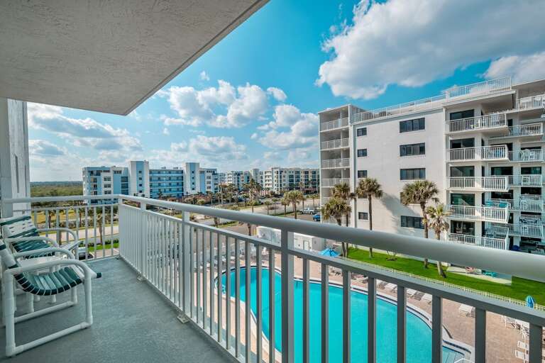 The spacious wrap-around corner balcony offers views of the Shorehom by the Sea pool