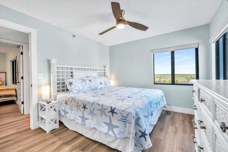 The sunny guest bedroom has a comfortable king bed