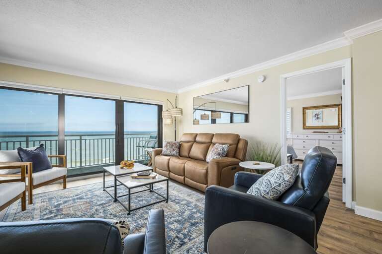 The comfortable living room offers stunning oceanfront views from this beautiful corner condo, making it the perfect spot to unwind and take in the scenery