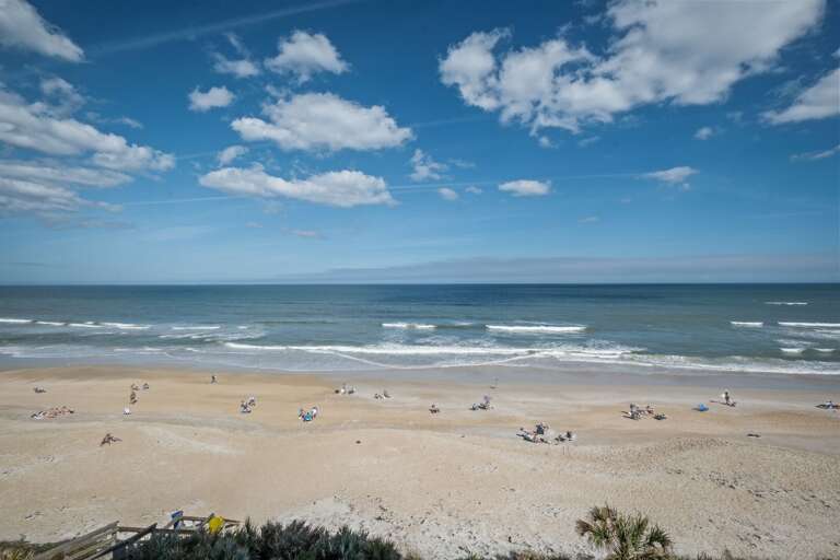 It's a gorgeous day at New Smyrna Beach, perfect for soaking up the sun and enjoying the beautiful coastline!