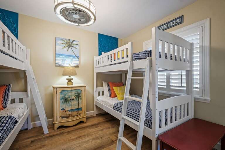The guest bedroom features two twin bunk beds, comfortably sleeping four guests