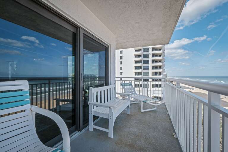 The large wraparound balcony offers plenty of seating, perfect for enjoying the stunning ocean views and fresh beach air