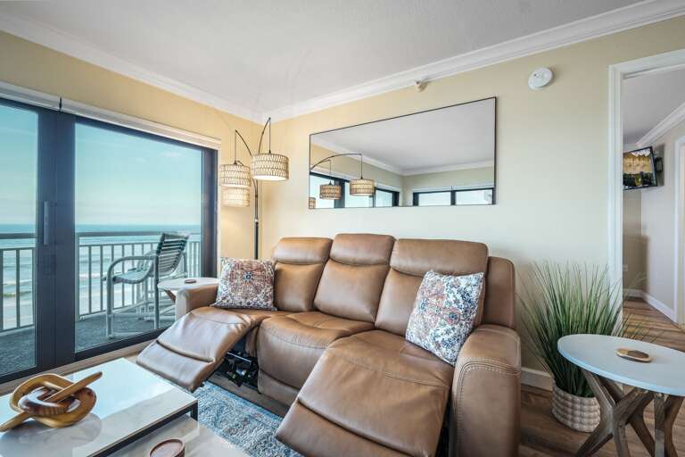 The living room features zero-gravity reclining sofas, offering the ultimate comfort while enjoying oceanfront views at Shorehom by the Sea 50