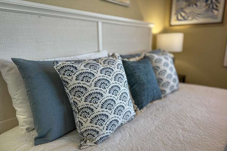 The master bedroom features a luxurious king bed, providing the perfect retreat with oceanfront views