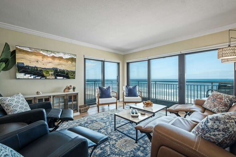 Relax in the oceanfront living room, featuring a zero-gravity reclining sofa and stunning views of the Atlantic