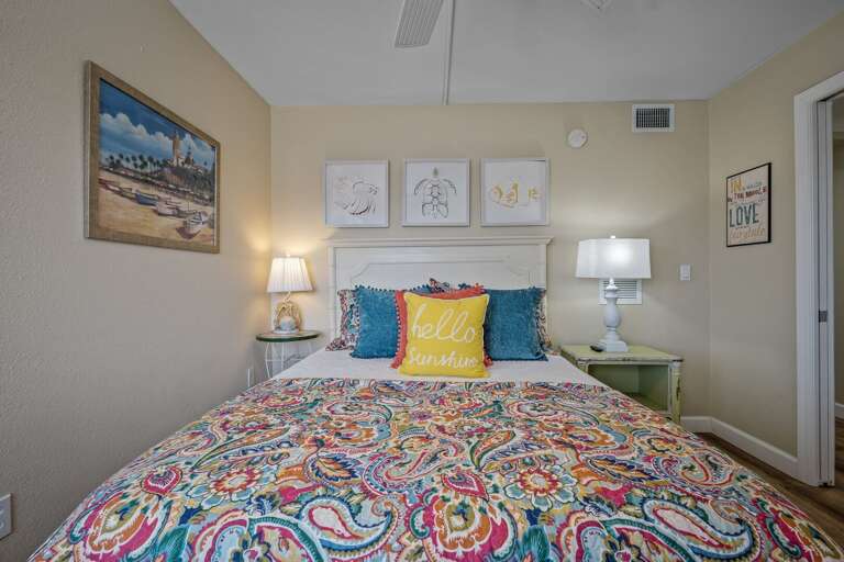 Say hello to sunshine in the guest bedroom, featuring a queen bed and a mounted TV