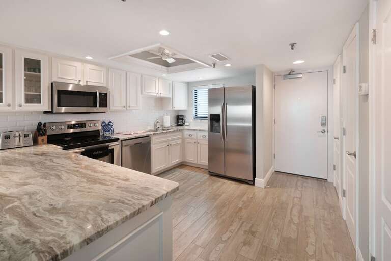 Spacious kitchen with bar top seating. Spacious kitchen with bar top seating.