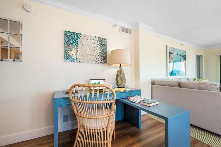 The dedicated work space by the living and dining room provides a functional area for work or planning your next beach adventure in New Smyrna Beach