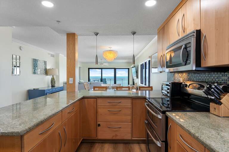 Enjoy preparing meals in the fully equipped kitchen with incredible views of the ocean right from the counter