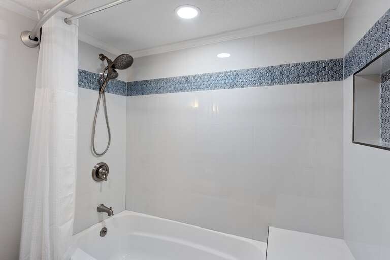 This condo features thoughtful design with luxurious touches, like the dual showerhead in the master bathroom, enhancing your New Smyrna Beach experience