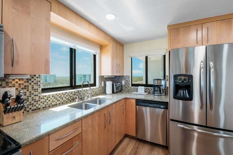 The kitchen is equipped with sleek stainless steel appliances