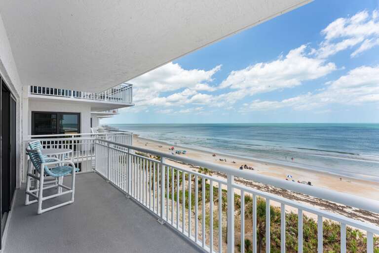 The private, 5th-floor oceanfront balcony offers breathtaking views of New Smyrna Beach, perfect for watching the sunrise
