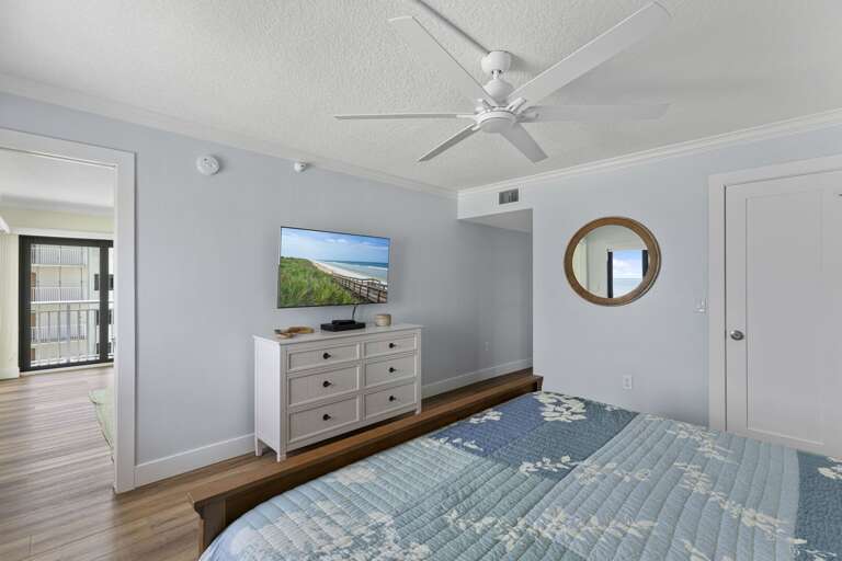 Relax in the master bedroom suite, complete with a large smart TV for your entertainment while enjoying the oceanfront views