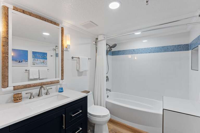 The recently renovated ensuite master bathroom features a tub/shower combo with dual shower heads