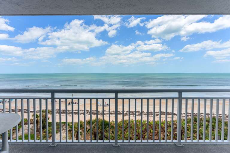 Step out onto the direct oceanfront 5th-floor balcony, where you can enjoy uninterrupted views of the Atlantic Ocean and the serene New Smyrna Beach shore