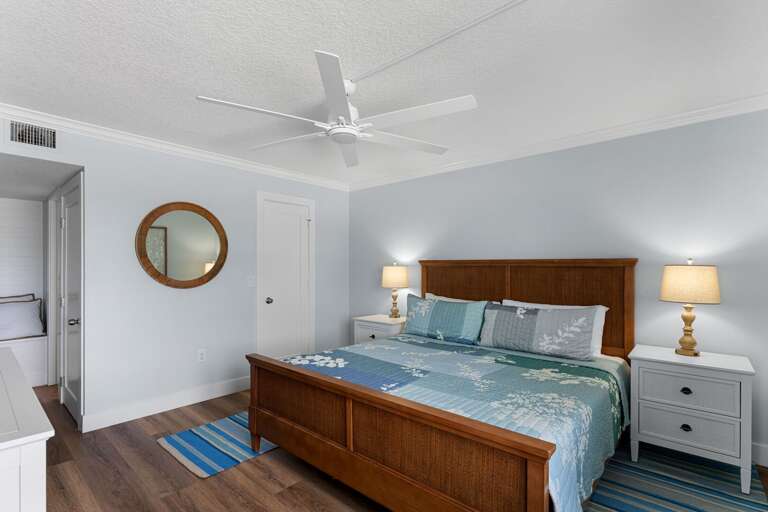 Unwind in the master bedroom suite with a king bed, oceanfront views, TV, generous closet storage, and an ensuite bathroom