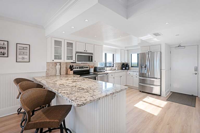Three bonus barstools are available at the kitchen counter, providing extra seating and a casual spot to enjoy a meal or snack