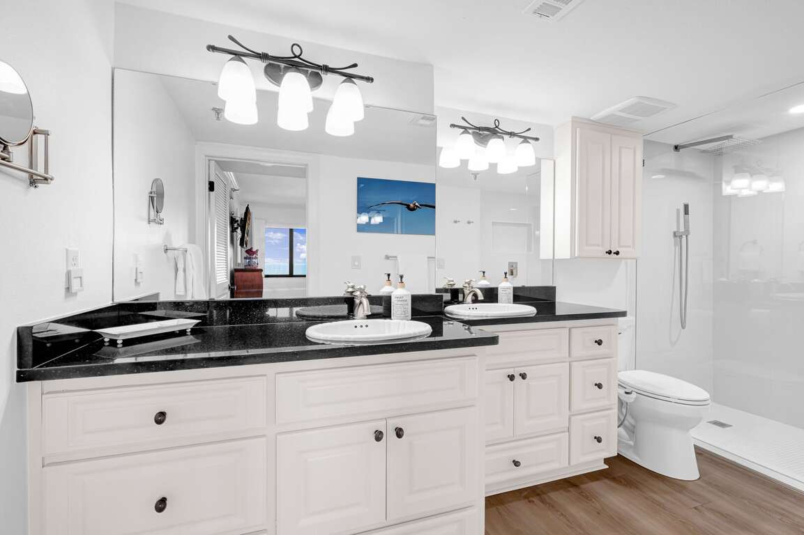 Indulge in a spa-like experience in the master bathroom, featuring a double vanity, granite countertops, and a beautiful walk-in shower Indulge in a spa-like experience in the master bathroom, featuring a double vanity, granite countertops, and a beautiful walk-in shower