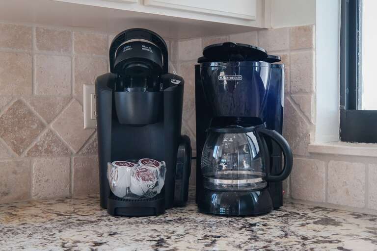 The kitchen is equipped with both a standard drip coffee maker and a Keurig, ensuring you have the perfect brew to start your day