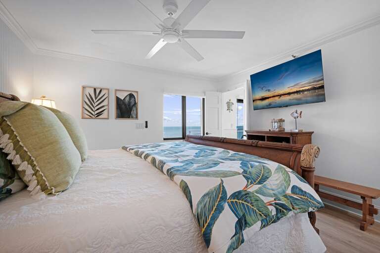 The master bedroom suite features a luxurious king bed, a mounted TV, ocean views, and a private ensuite bathroom for the ultimate comfort and relaxation The master bedroom suite features a luxurious king bed, a mounted TV, ocean views, and a private ensuite bathroom for the ultimate comfort and relaxation