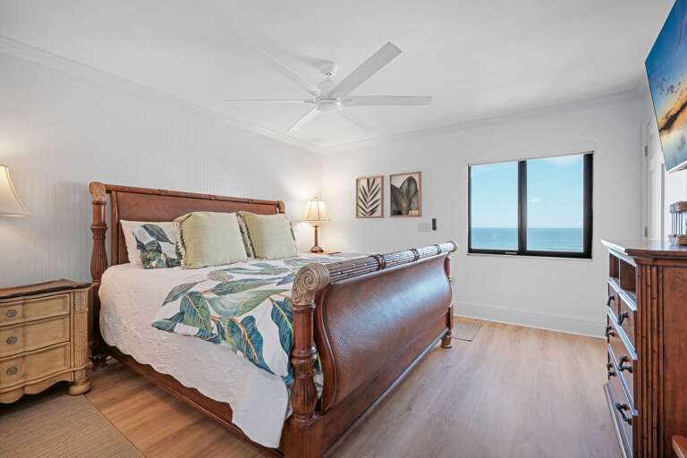 The oceanfront master bedroom boasts a luxurious king bed and stunning views of the Atlantic Ocean The oceanfront master bedroom boasts a luxurious king bed and stunning views of the Atlantic Ocean