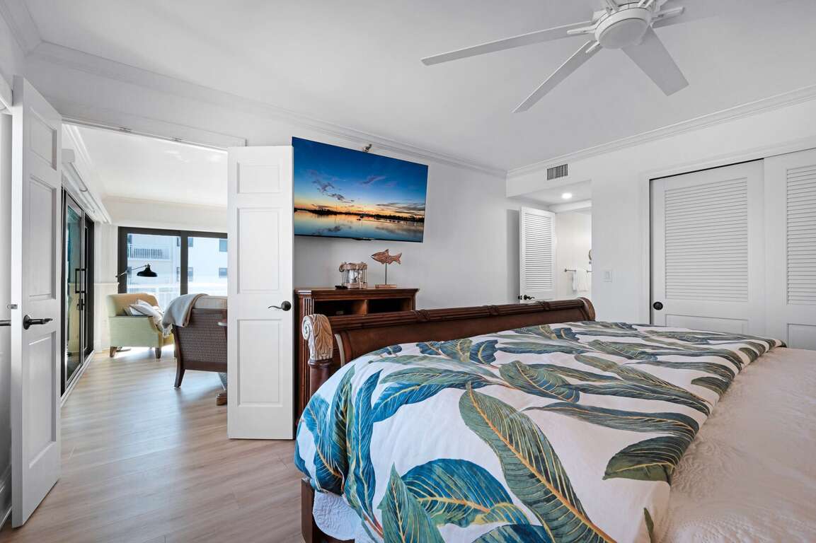 Relax in the master bedroom suite, featuring a luxurious king bed, a TV for your entertainment, and a private ensuite bathroom Relax in the master bedroom suite, featuring a luxurious king bed, a TV for your entertainment, and a private ensuite bathroom