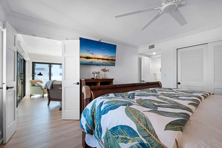 Relax in the master bedroom suite, featuring a luxurious king bed, a TV for your entertainment, and a private ensuite bathroom