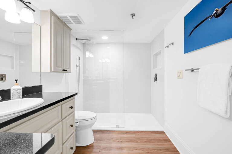 Unwind in the master bathroom's sleek glass and tile shower. Plush, white towels add a touch of indulgence Unwind in the master bathroom's sleek glass and tile shower. Plush, white towels add a touch of indulgence
