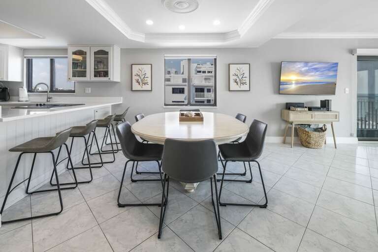 The corner condo's panoramic ocean views provide a stunning backdrop as you eat at the dining room table