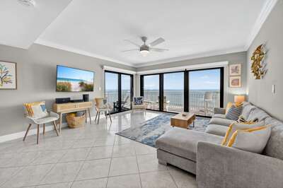 Unwind after a day at the beach on the comfortable sectional sofa in the oceanfront living room