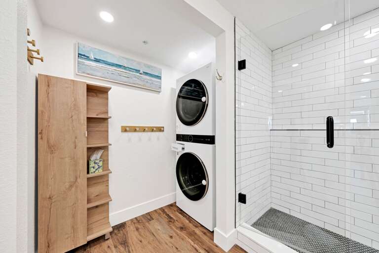 A full sized washer and dryer is located inside the guest bathroom