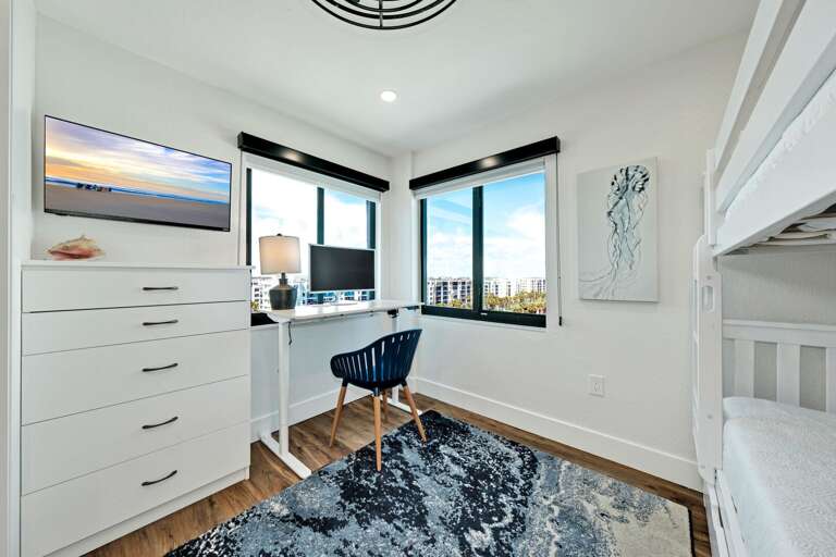 West facing guest bedroom with a mounted TV