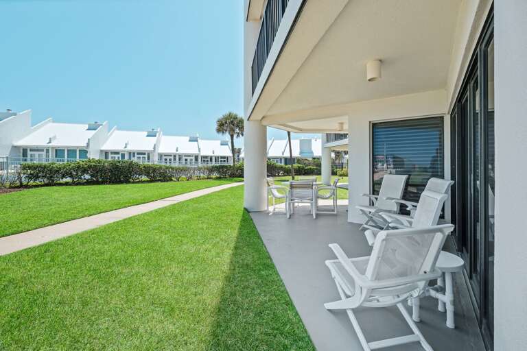 Ground floor patio steps away from the pool and beach