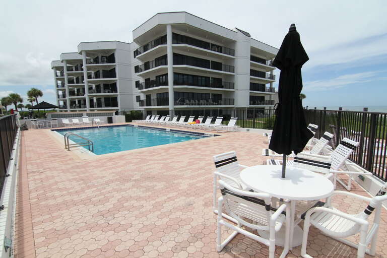 Tables and chairs perfect for relaxing by the pool.