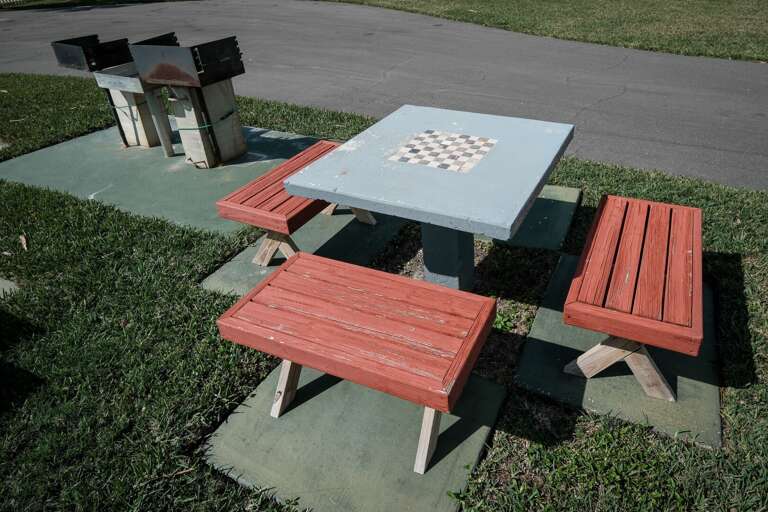 Enjoy the charcoal grill area with seating, perfect for outdoor cooking and dining