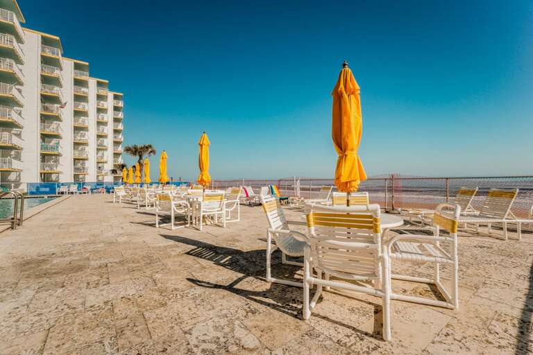 Relax with tables, umbrellas, and chairs on the beachfront pool deck, where you can enjoy ocean views while soaking up the sun at Smyrna Beach Club