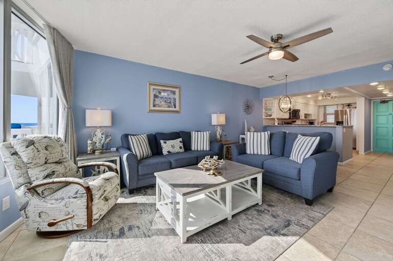 Cozy up in the coastal-chic living room, where ocean views meet total comfort. Cozy up in the coastal-chic living room, where ocean views meet total comfort.