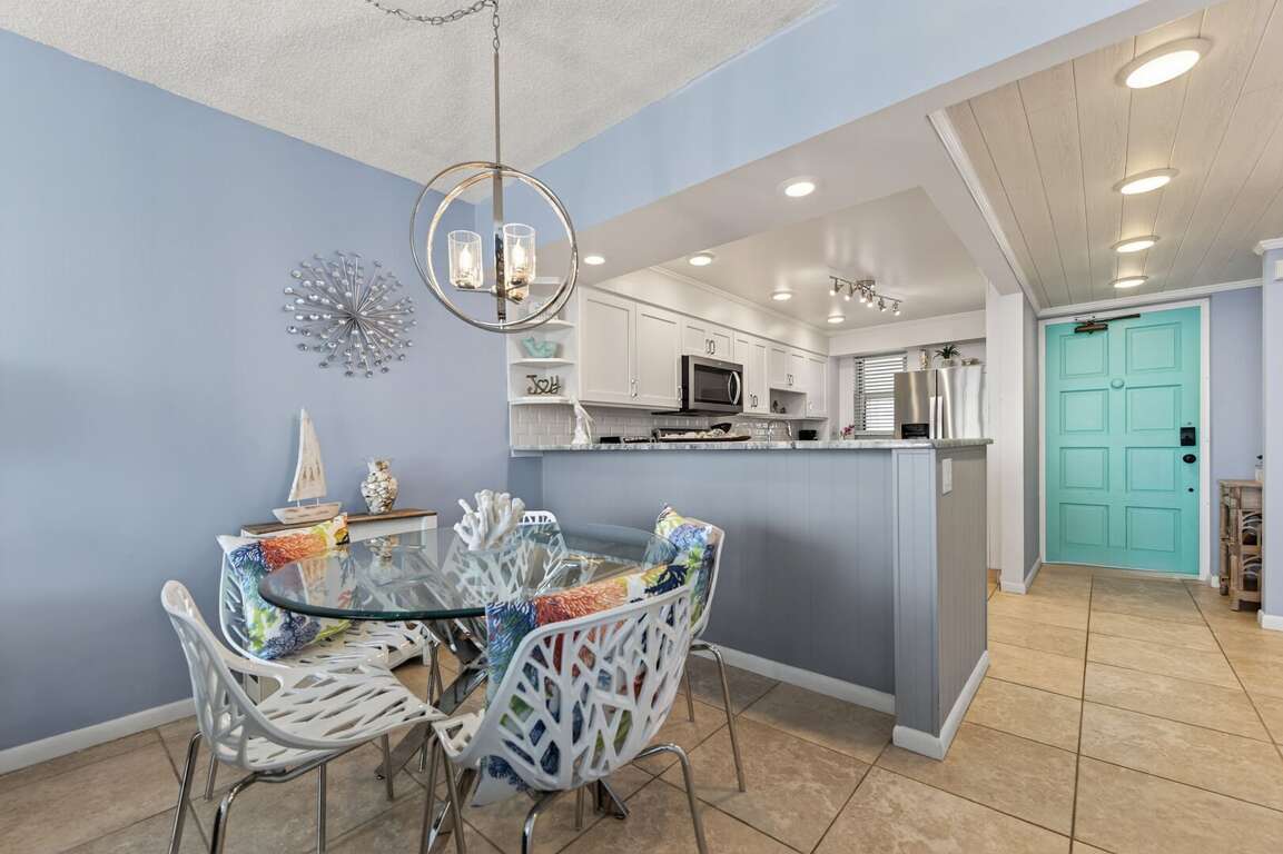 Enjoy meals in the bright, open-concept dining area with coastal charm and seating for four. Enjoy meals in the bright, open-concept dining area with coastal charm and seating for four.
