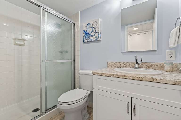Freshen up in the stylish guest bathroom featuring a convenient step-in shower and clean, modern design. Freshen up in the stylish guest bathroom featuring a convenient step-in shower and clean, modern design.