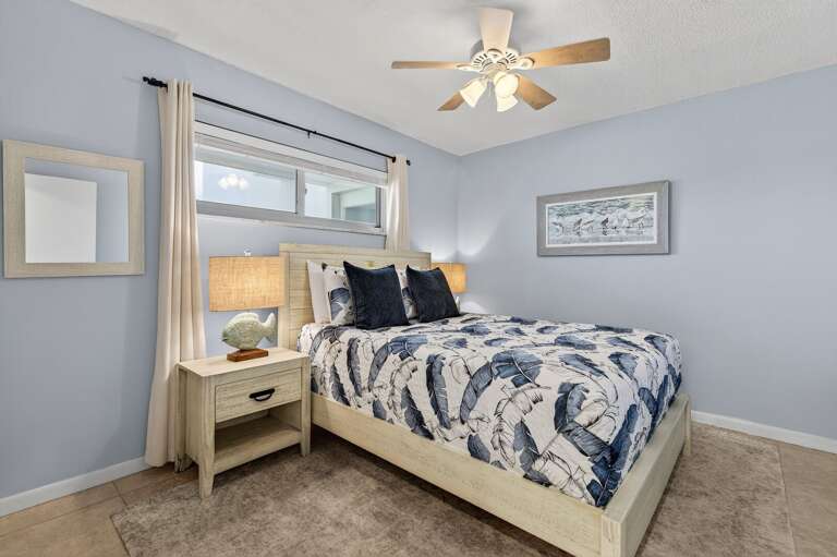 Rest easy in the cozy guest bedroom with a queen bed and calming beach-inspired decor. Rest easy in the cozy guest bedroom with a queen bed and calming beach-inspired decor.