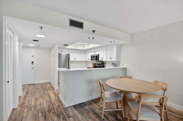 Gather for meals or game night at the dining table with seating for four, conveniently located next to the beautifully updated kitchen Gather for meals or game night at the dining table with seating for four, conveniently located next to the beautifully updated kitchen