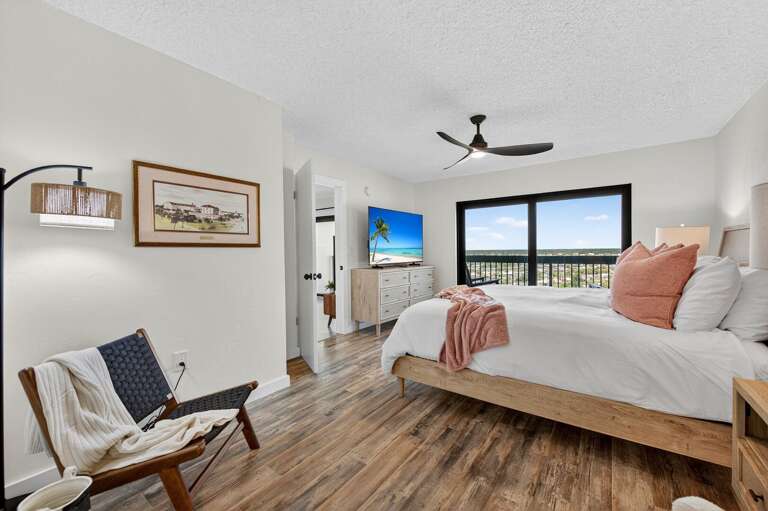 This serene primary bedroom features a plush king bed, large smart TV, and private ensuite bathroom This serene primary bedroom features a plush king bed, large smart TV, and private ensuite bathroom