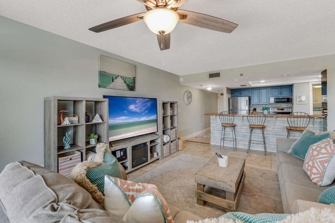 Enjoy the renovated living room featuring a large TV and beach-inspired décor—your perfect spot to unwind after a day by the ocean Enjoy the renovated living room featuring a large TV and beach-inspired décor—your perfect spot to unwind after a day by the ocean