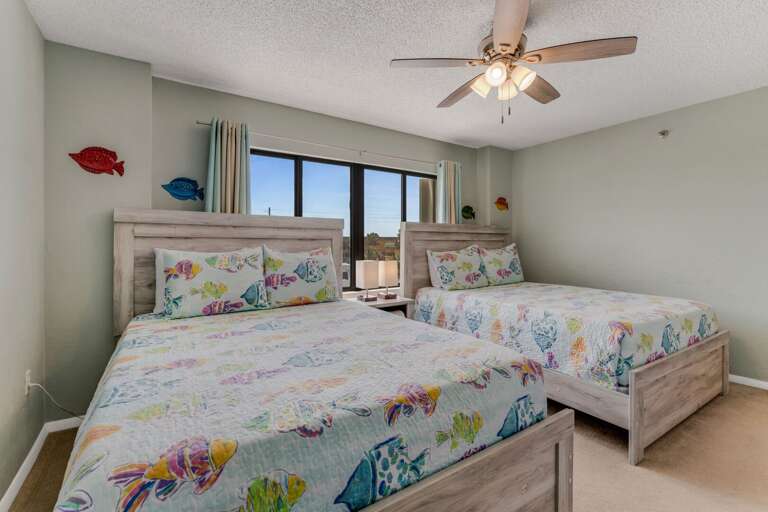 Guest bedroom featuring two comfortable queen beds—ideal for families or groups traveling together Guest bedroom featuring two comfortable queen beds—ideal for families or groups traveling together