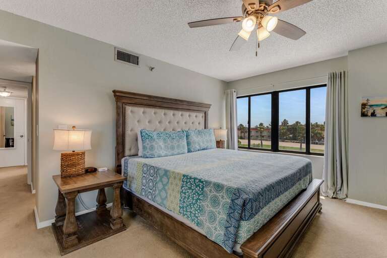 Rest easy in the master bedroom's spacious king bed, designed for ultimate comfort after a day by the ocean Rest easy in the master bedroom's spacious king bed, designed for ultimate comfort after a day by the ocean