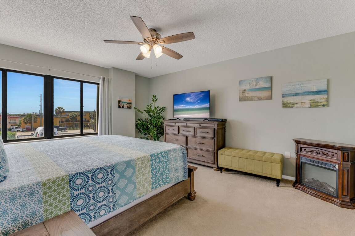 Serene master bedroom featuring a king bed, large TV, and private ensuite bathroom for your comfort and privacy Serene master bedroom featuring a king bed, large TV, and private ensuite bathroom for your comfort and privacy