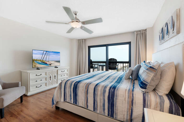 The Master Bedroom includes a King bed, TV, and private access to the balcony overlooking Ormond Beach The Master Bedroom includes a King bed, TV, and private access to the balcony overlooking Ormond Beach
