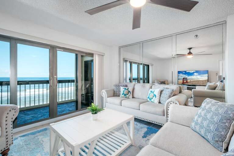 Bright and beachy, the oceanfront living room features coastal blue décor and stunning views of the Atlantic Bright and beachy, the oceanfront living room features coastal blue décor and stunning views of the Atlantic