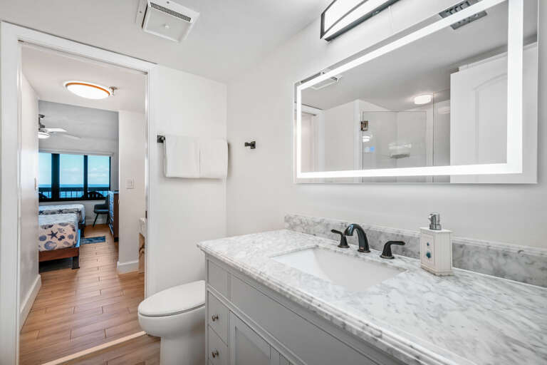 The north guest bedroom includes a private ensuite bathroom with an anti-fog mirror and a tile shower The north guest bedroom includes a private ensuite bathroom with an anti-fog mirror and a tile shower