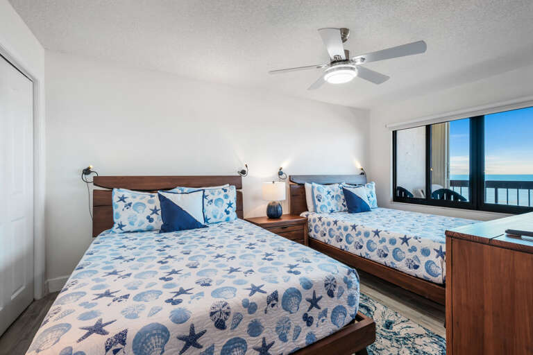Oceanfront north guest bedroom with two queen beds and an ensuite bathroom Oceanfront north guest bedroom with two queen beds and an ensuite bathroom